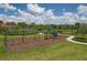 Well-equipped playground with swings and climbing area surrounded by green space and trees at 13232 Saw Palm Creek Trl, Bradenton, FL 34211