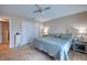 Comfortable bedroom features neutral color scheme, wood-look flooring, and ample closet space at 13575 Martha Ave, Port Charlotte, FL 33981