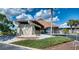 Elegant clubhouse featuring stone facade, manicured landscaping, and a welcoming entrance at 13575 Martha Ave, Port Charlotte, FL 33981
