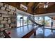 Air hockey table in a well-lit game room with stone accents and beautiful outdoor views at 13575 Martha Ave, Port Charlotte, FL 33981