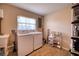 Functional laundry room equipped with modern washer, dryer, and ample storage space at 13575 Martha Ave, Port Charlotte, FL 33981