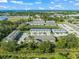 An aerial view of the community, featuring lush greenery and a beautiful ocean in the background at 17136 Blowfish Dr, Nokomis, FL 34275