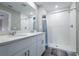 Bathroom featuring double sinks, tile flooring, and a walk-in shower at 17136 Blowfish Dr, Nokomis, FL 34275