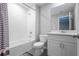 Clean, well-lit bathroom with modern fixtures, a shower-tub combo, and a sleek vanity at 17136 Blowfish Dr, Nokomis, FL 34275