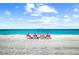 Beautiful beach scene with lounge chairs, white sand, and ocean views, perfect for relaxation at 17136 Blowfish Dr, Nokomis, FL 34275