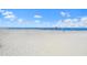 Sandy beach scene with colorful umbrellas dotting the shoreline under a clear sky at 17136 Blowfish Dr, Nokomis, FL 34275