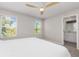Bedroom with ceiling fan, carpet, and plenty of natural light and an ensuite bathroom at 17136 Blowfish Dr, Nokomis, FL 34275