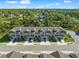 Aerial view of townhome exteriors showing front yards and attached garages at 17136 Blowfish Dr, Nokomis, FL 34275