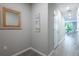 Hallway featuring a view to the living space, neutral paint and tile floors at 17136 Blowfish Dr, Nokomis, FL 34275