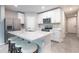 Well-equipped kitchen with stainless appliances, kitchen island and sleek white cabinets at 17136 Blowfish Dr, Nokomis, FL 34275