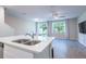 Bright kitchen with quartz countertops, stainless steel appliances, and an open view to the living area at 17136 Blowfish Dr, Nokomis, FL 34275