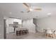Open concept kitchen with white cabinets, stainless appliances, and a center island with bar stool seating at 17136 Blowfish Dr, Nokomis, FL 34275