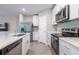 Modern kitchen with stainless steel appliances, quartz countertops, and lots of storage space at 17136 Blowfish Dr, Nokomis, FL 34275