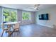 Open-concept living space with wood tile flooring, ceiling fan, and sliding glass doors to a patio at 17136 Blowfish Dr, Nokomis, FL 34275
