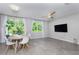 Open living room featuring tile floors, recessed lighting, ceiling fan, and sliding door to outdoor patio at 17136 Blowfish Dr, Nokomis, FL 34275