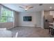 Inviting living space with tile flooring, view of the kitchen, stainless refrigerator, and backyard views at 17136 Blowfish Dr, Nokomis, FL 34275