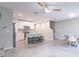 Open-concept living area with sleek tile floors, modern kitchen, island seating, and bright, inviting design at 17136 Blowfish Dr, Nokomis, FL 34275