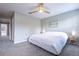Cozy bedroom with a ceiling fan, neutral walls, carpet, and a beach-themed decor at 17136 Blowfish Dr, Nokomis, FL 34275