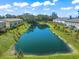 Picturesque pond surrounded by lush lawns and well-maintained townhomes at 17136 Blowfish Dr, Nokomis, FL 34275