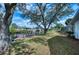 Lush backyard with mature trees, a private dock, and waterfront access at 18576 Alphonse Cir, Port Charlotte, FL 33948