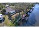 Waterfront backyard with a dock and a screened lanai, perfect for outdoor entertaining at 18576 Alphonse Cir, Port Charlotte, FL 33948