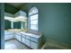 Bathroom featuring tiled floors, a large vanity, and arched window at 18576 Alphonse Cir, Port Charlotte, FL 33948
