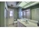 Well-lit bathroom with a sink, vanity, shower, toilet, and ample storage at 18576 Alphonse Cir, Port Charlotte, FL 33948
