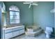 Bathroom with a tiered soaking tub, a decorative window, and a vanity with storage at 18576 Alphonse Cir, Port Charlotte, FL 33948
