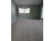 Spacious carpeted bedroom with neutral decor, bright natural light, and simple window treatments at 18576 Alphonse Cir, Port Charlotte, FL 33948