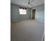 Inviting carpeted bedroom featuring a ceiling fan, closet, and a window at 18576 Alphonse Cir, Port Charlotte, FL 33948
