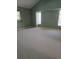 Large bedroom with neutral carpeting, light green walls, and plenty of natural light at 18576 Alphonse Cir, Port Charlotte, FL 33948
