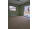 Bedroom with neutral carpet, a sliding glass door to the pool, and a ceiling fan at 18576 Alphonse Cir, Port Charlotte, FL 33948