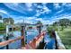 Dock with boat lift overlooking the calm water, offering convenience for boating enthusiasts at 18576 Alphonse Cir, Port Charlotte, FL 33948