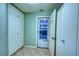 Hallway with built in storage and access to the garage. Tile floor with green walls at 18576 Alphonse Cir, Port Charlotte, FL 33948