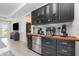 Elegant bar area with custom cabinetry, stainless steel appliances, and a view into the living room at 1944 Vang Ln, Sarasota, FL 34240