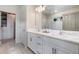 Bright bathroom featuring a double vanity with marble countertop and modern fixtures, alongside a glass-enclosed shower at 1944 Vang Ln, Sarasota, FL 34240
