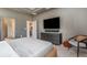 Bedroom with a large TV over a sleek dresser, complemented by a comfortable chair and stylish decor at 1944 Vang Ln, Sarasota, FL 34240