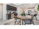 Chic dining area adjacent to the kitchen, featuring black cabinets and a stylish round table with seating at 1944 Vang Ln, Sarasota, FL 34240