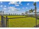 Community dog park featuring well-maintained green space with palm trees and a view of the lake at 1944 Vang Ln, Sarasota, FL 34240
