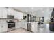 Bright kitchen featuring white cabinetry, stainless steel appliances, and an open layout connected to the living area at 1944 Vang Ln, Sarasota, FL 34240