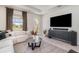 Comfortable living room with a large sectional sofa, modern decor, and a view to the backyard at 1944 Vang Ln, Sarasota, FL 34240