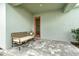 Inviting covered porch with stylish bench seating, plants, and tiled flooring, creating a cozy outdoor entrance at 1944 Vang Ln, Sarasota, FL 34240
