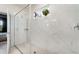 Modern glass-enclosed shower with marble-look tile, dual shower heads, and decorative accents at 1944 Vang Ln, Sarasota, FL 34240