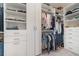 Spacious walk-in closet with custom shelving, drawers, and ample storage for clothes and accessories at 1944 Vang Ln, Sarasota, FL 34240