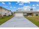 Charming single-story home with a well-manicured lawn and a long driveway at 23 Ocean Dr, Punta Gorda, FL 33950