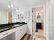 Stylish bathroom with granite countertop vanity, ample lighting, and neutral wall and floor tiling at 2424 Placida Rd # C104, Englewood, FL 34224