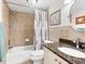 Bathroom featuring granite counters, tiled shower and tub, and neutral color scheme at 2424 Placida Rd # C104, Englewood, FL 34224