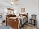 Comfortable bedroom with a full-sized bed, wood furnishings, and bright interior at 2424 Placida Rd # C104, Englewood, FL 34224