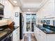 Bright kitchen featuring white cabinetry, granite counters, and stainless steel appliances at 2424 Placida Rd # C104, Englewood, FL 34224