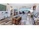 Inviting living room boasts wood-look flooring, a comfortable seating area, and a picturesque bay view at 2424 Placida Rd # C104, Englewood, FL 34224